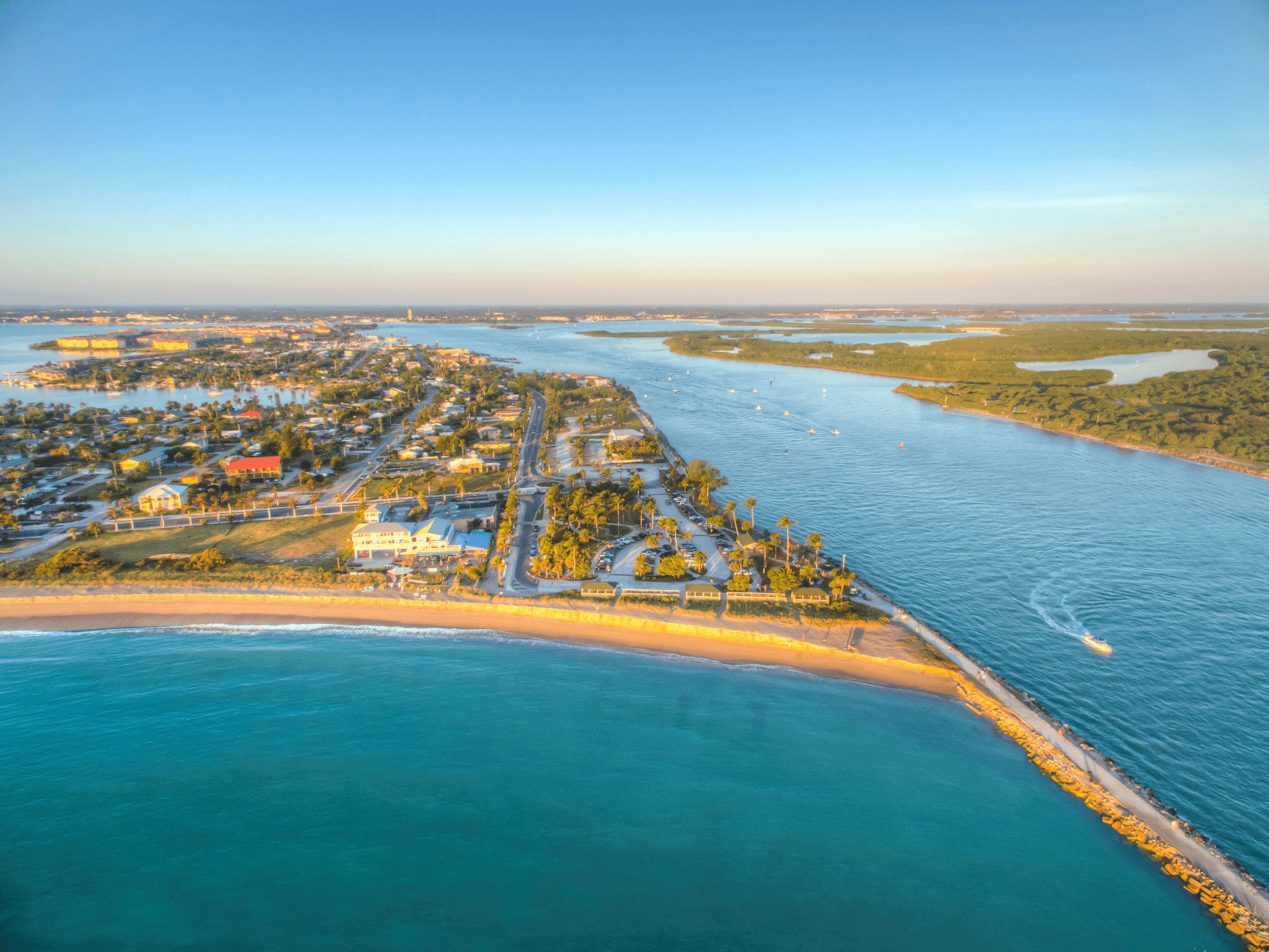 A beach with a body of water and a city