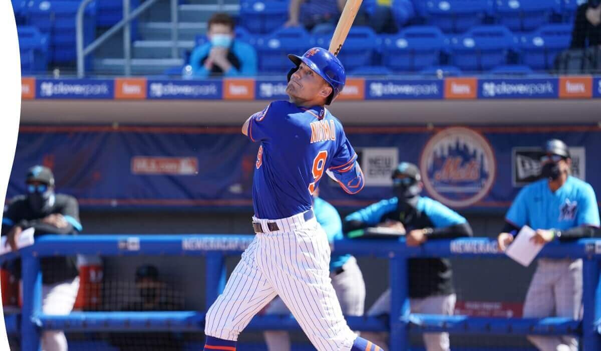 Baseball player swinging a bat in a stadium