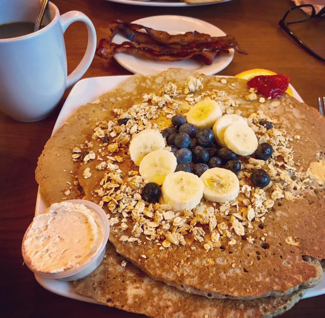 A stack of pancakes with bananas and blueberries in St. Lucie.