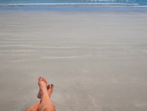 Feet in the sandy beach in St. Lucie, Florida. 