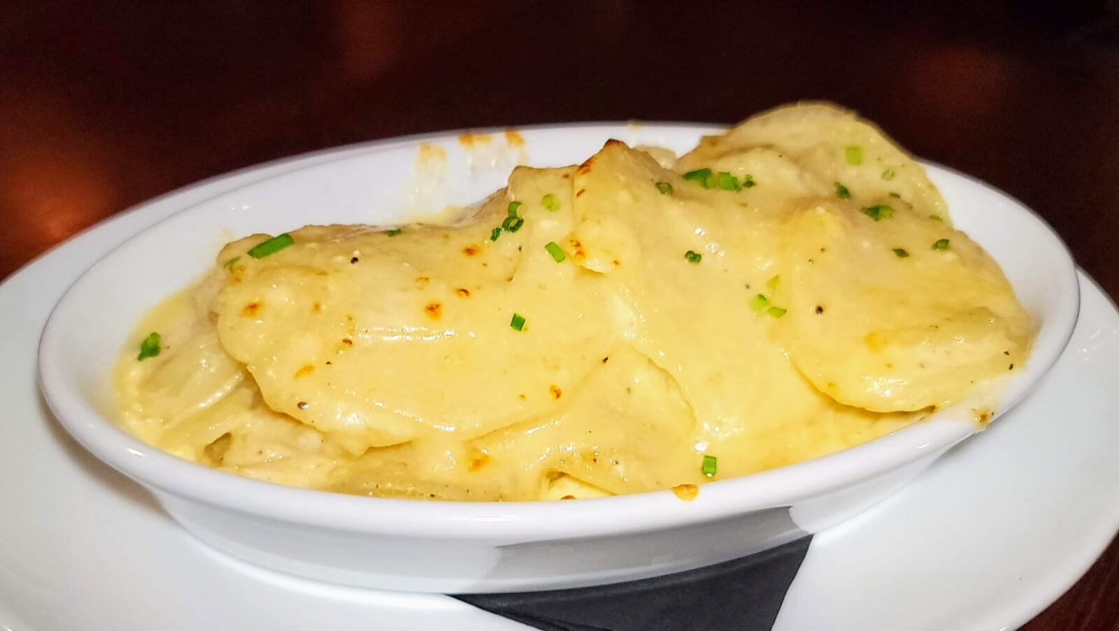 A serving bowl of Au Gratin Potatoes at The Fort Steakhouse in Fort Pierce, Florida.