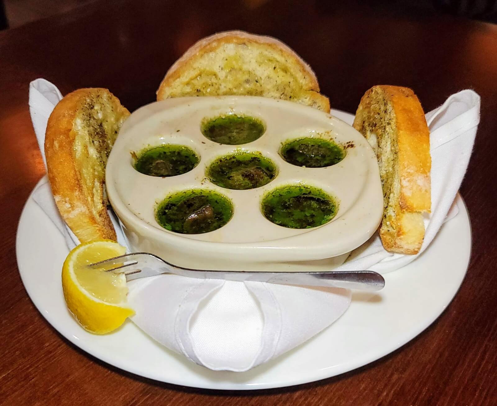 A dish of cliced bread and dipping sauce on a platter at The Fort Steakhouse in Fort Pierce, Florida. 